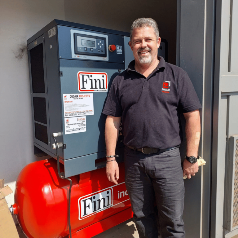Colin van Aardt of DuoAir Projects in front of a Finis compressor